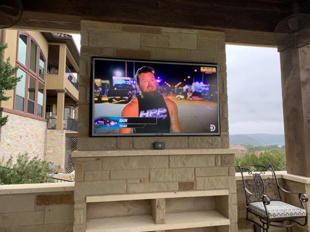 TV on stone wall on patio